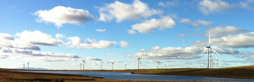 Photograph of windfarm, moorland and loch.
