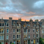 Cloudy sunset behind buildings