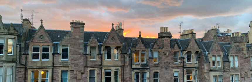 Cloudy sunset behind buildings
