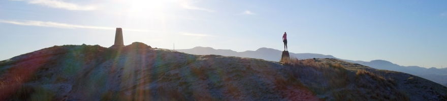 Woman standing on a stone at the top of Blackford Hill