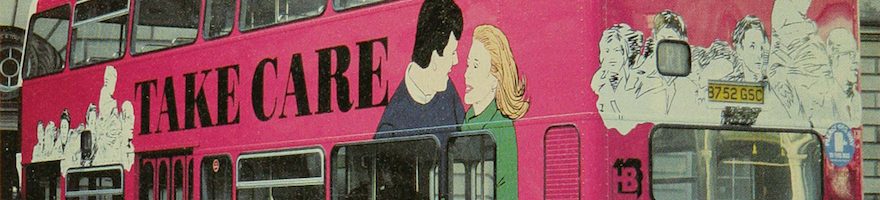 Pink double decker bus with 'Take Care AIDS concerns us all' written on the side