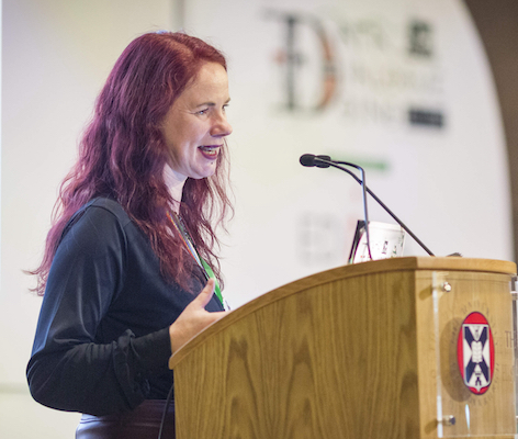 photograph of Lorna Campbell standing at a lectern at the ALT Conference at the University of Edinburgh.