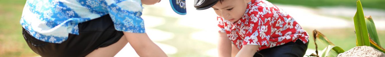 Two children playing in pond